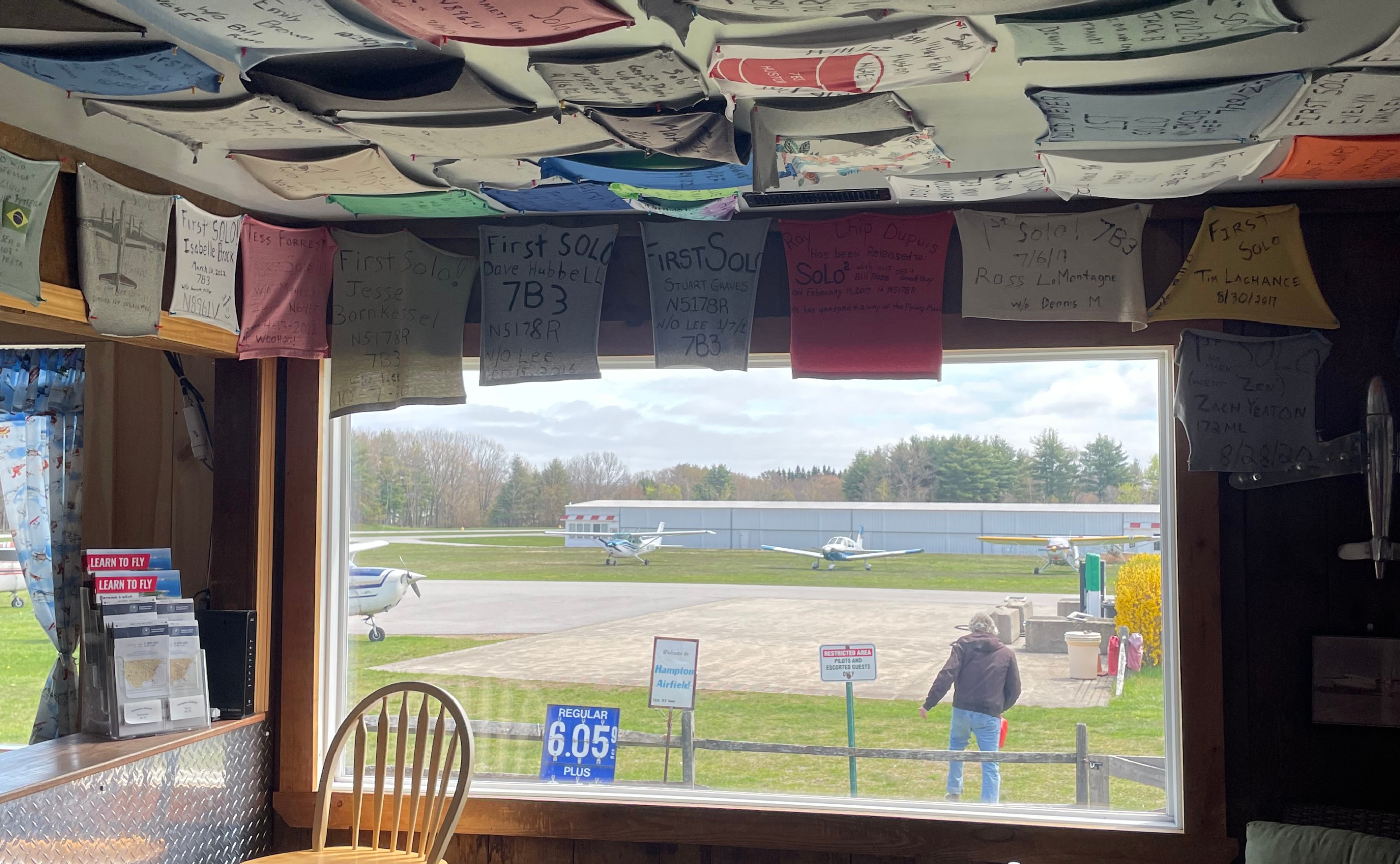 View across an airport flightline framed by first-solo keepsakes